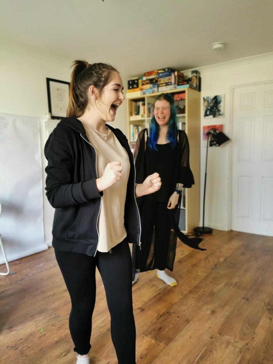 Vicky in the foreground with Jay behind her, performing a 'fun run' in preparation for the performance.